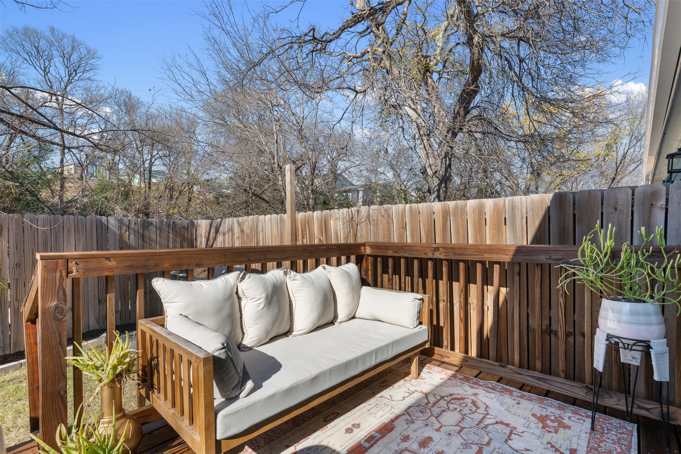 1616 Webberville Road, Unit A Austin, TX 78721 - Photo 14 of 28 Wooden terrace featuring outdoor lounge area and a fenced backyard
