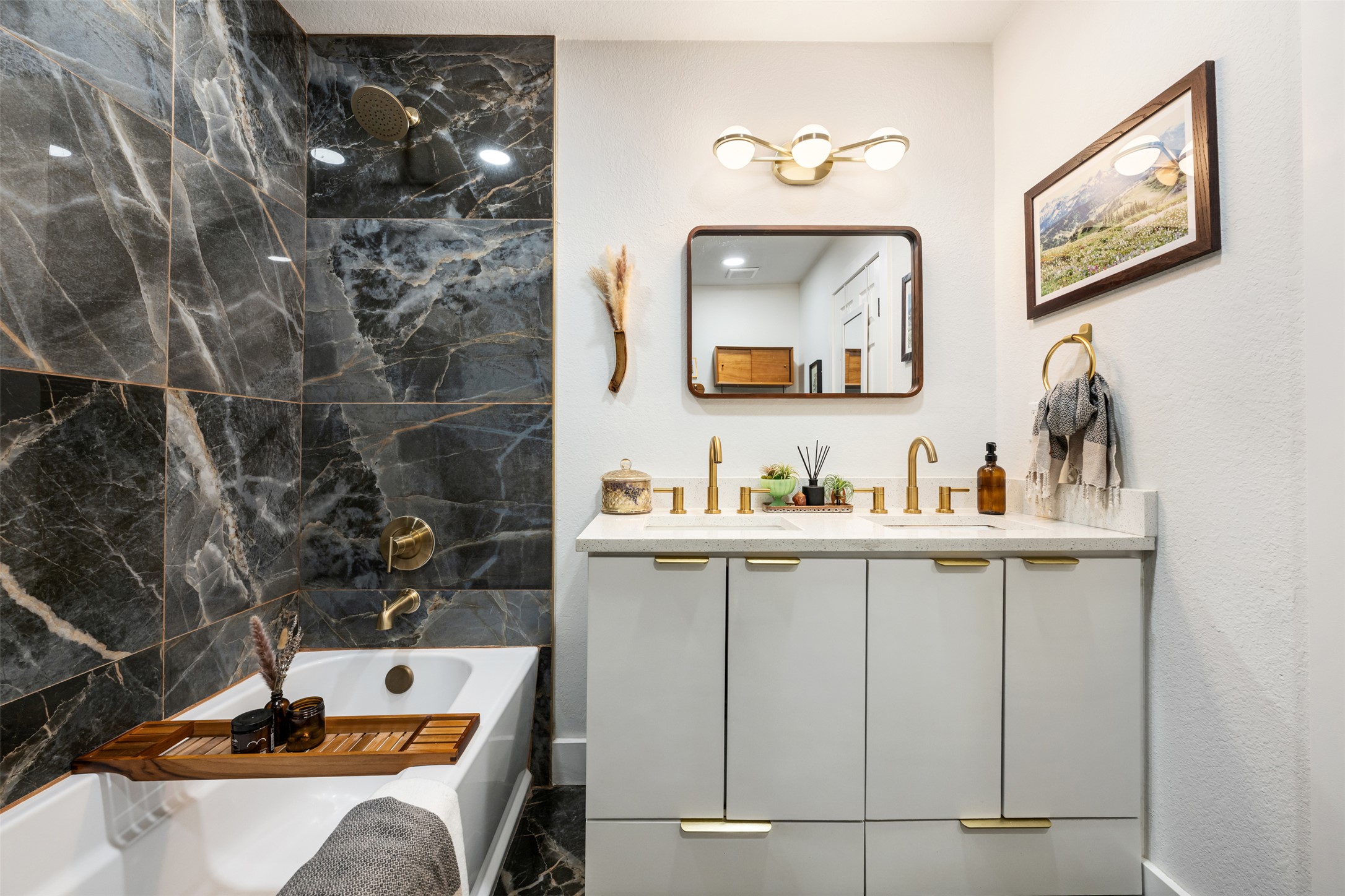 1616 Webberville Road, Unit A Austin, TX 78721 - Photo 15 of 27 a view of a bathroom with a sink and mirror
