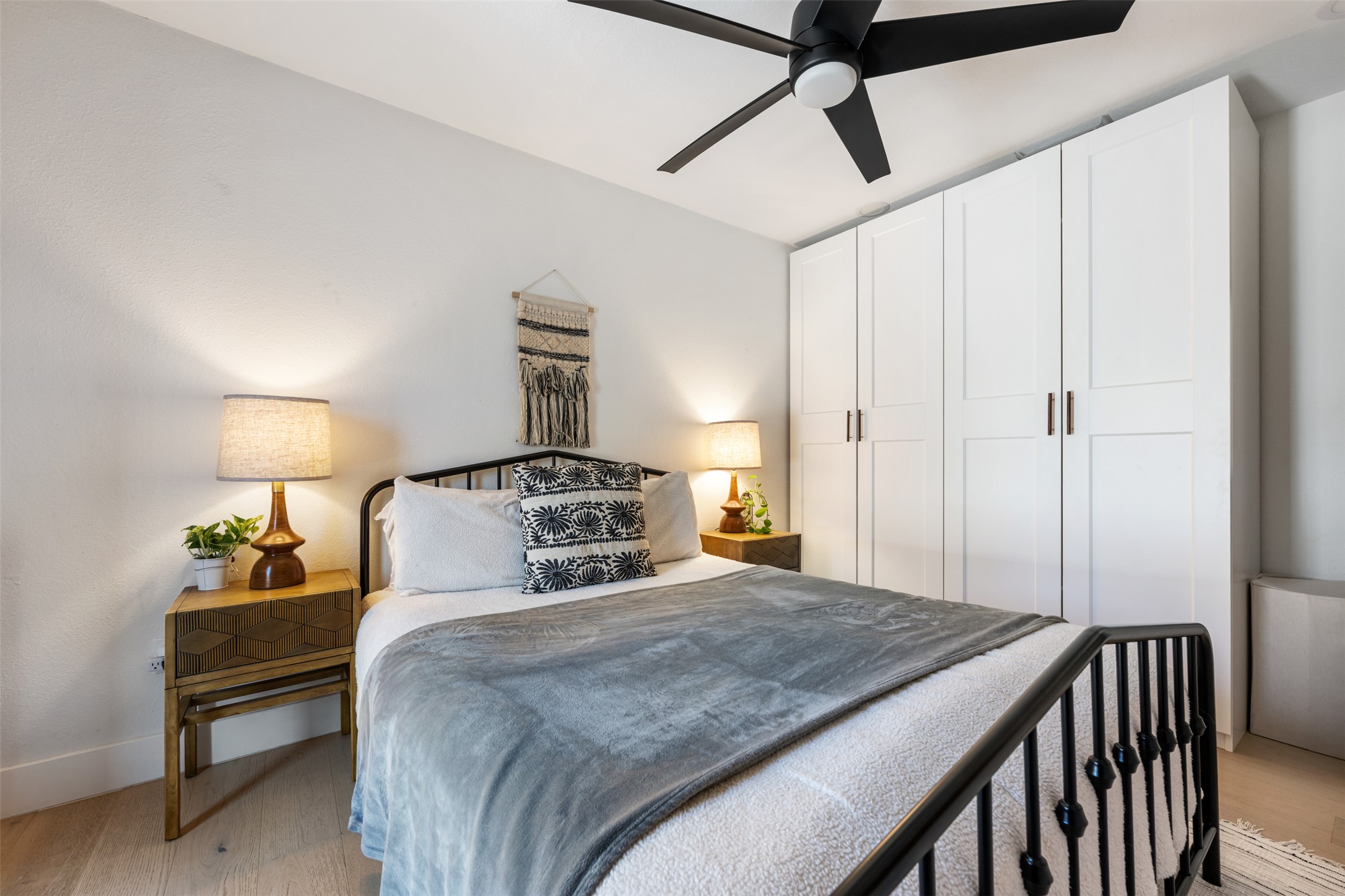 1616 Webberville Road, Unit A Austin, TX 78721 - Photo 15 of 28 Bedroom featuring light wood-style floors and ceiling fan