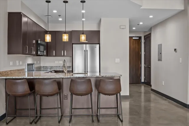 a kitchen with granite countertop a sink and cabinets