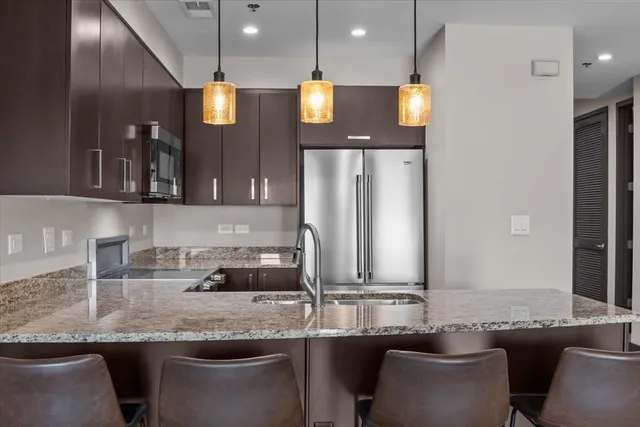 a kitchen with granite countertop a stove and a sink