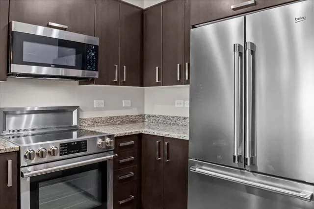 a living room with furniture a window and a potted plant