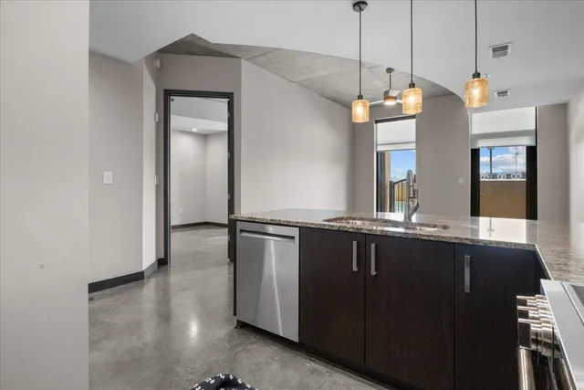 an empty room with windows and cabinet
