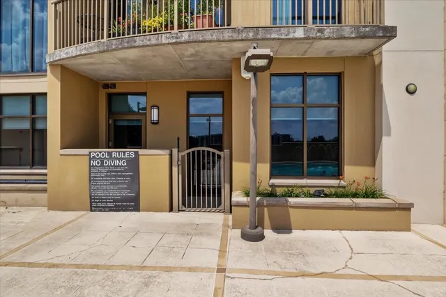 an empty room with wooden floor mirror and entryway