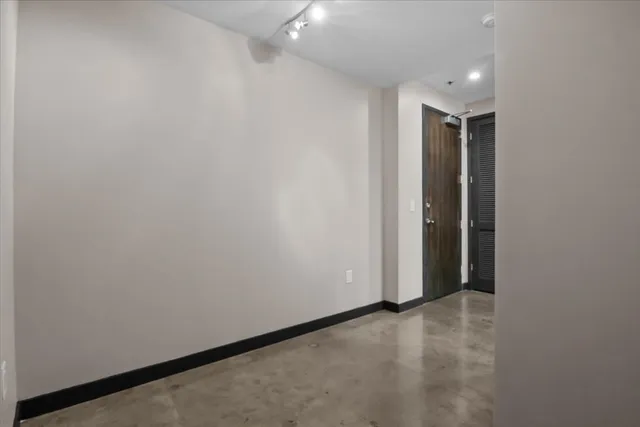 a kitchen with stainless steel appliances granite countertop a kitchen island a stove and a refrigerator