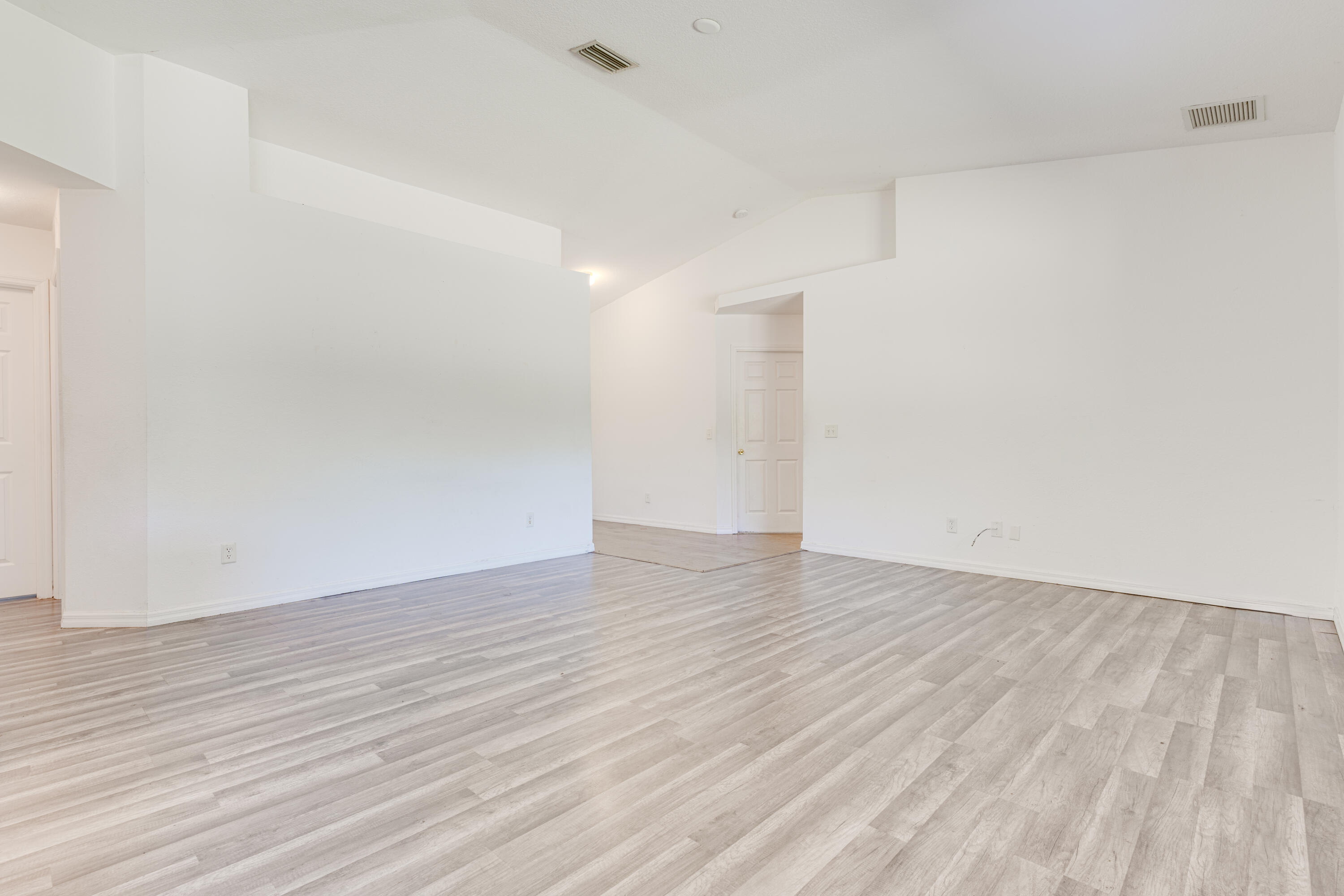 500 Topeka Road Southwest Palm Bay, FL 32908 - Photo 5 of 12 a view of an empty room with wooden floor