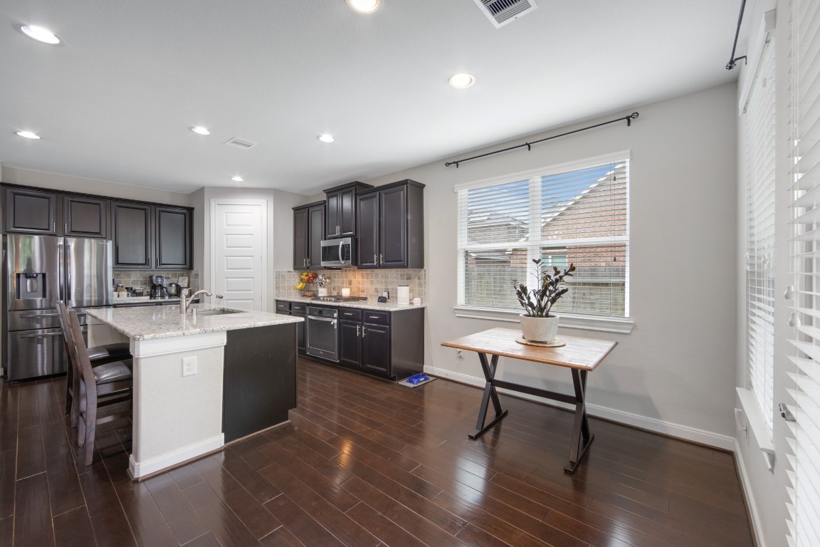 22622 Cutter Mill Drive Spring, TX 77389 - Photo 13 of 40 KITCHEN – ISLAND FOCAL POINT
Oversized granite island with bar seating offers the perfect gathering space for cooking, conversation, and casual dining.
