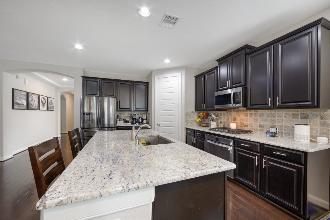 22622 Cutter Mill Drive Spring, TX 77389 - Photo 14 of 40 KITCHEN – CABINET + APPLIANCE VIEW
Rich cabinetry, stainless steel appliances, and a stylish backsplash create a clean, modern look with timeless appeal.