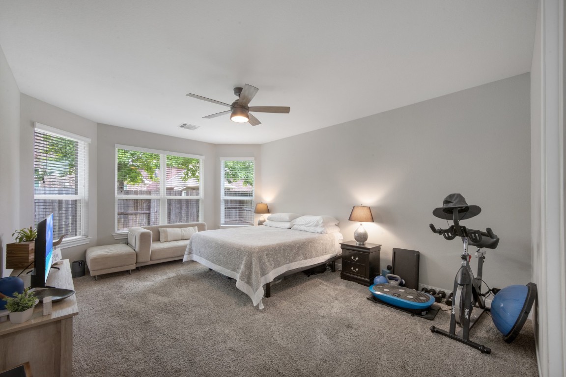 22622 Cutter Mill Drive Spring, TX 77389 - Photo 21 of 40 PRIMARY BEDROOM – MAIN VIEW
Spacious primary suite with plush carpeting, abundant natural light, and room for a sitting area creates a comfortable private retreat.