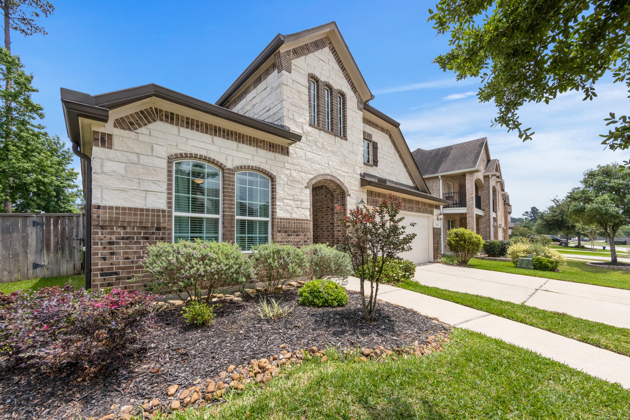 22622 Cutter Mill Drive Spring, TX 77389 - Photo 3 of 40 FRONT (ANGLE W/ LANDSCAPING)
Beautifully maintained exterior with lush landscaping, mature greenery, and a welcoming approach that sets the tone before you even step inside.