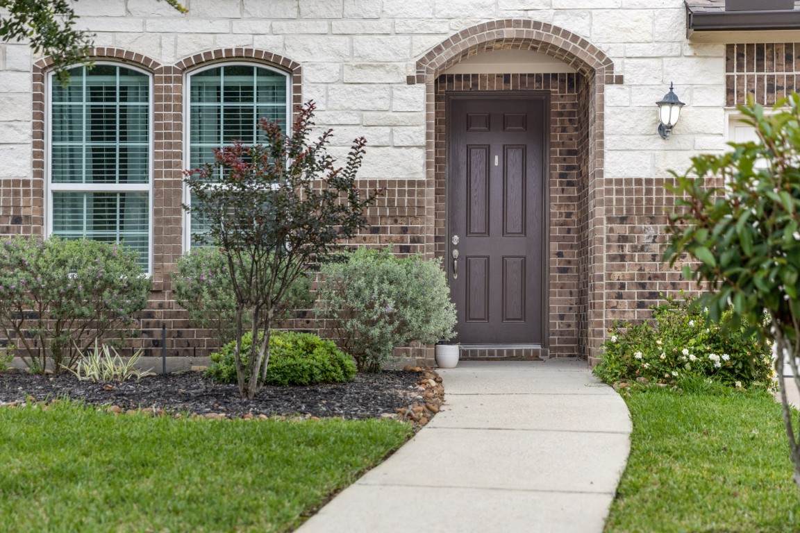 22622 Cutter Mill Drive Spring, TX 77389 - Photo 7 of 40 FRONT ENTRY
Inviting covered entry with arched detail creates a warm and welcoming first impression for guests and everyday arrivals.
