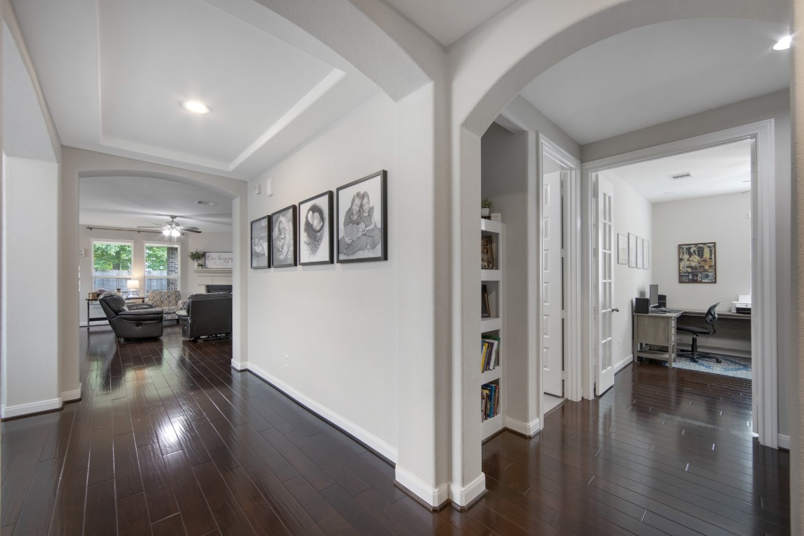 22622 Cutter Mill Drive Spring, TX 77389 - Photo 8 of 40 ENTRYWAY – Step inside and immediately feel the openness—soaring ceilings, rich wood floors, and a flowing layout that draws you effortlessly into the heart of the home.