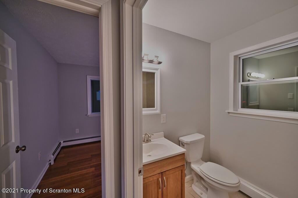 978 Goose Pond Road Lake Ariel, PA 18436 - Photo 16 of 44 a bathroom with a toilet a sink and mirror