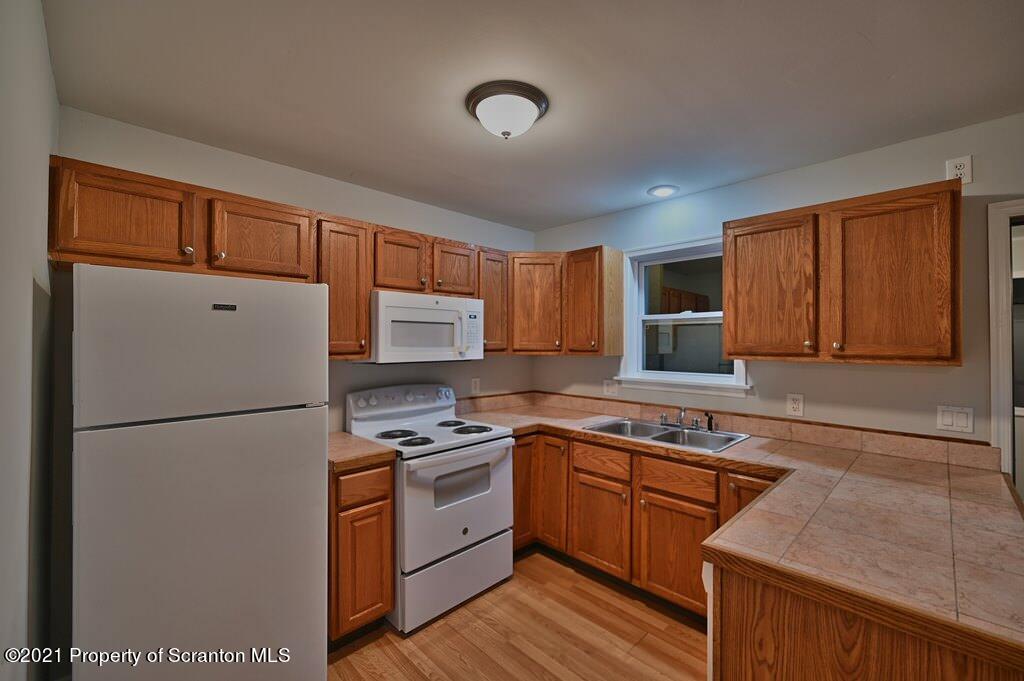 978 Goose Pond Road Lake Ariel, PA 18436 - Photo 17 of 44 a kitchen with stainless steel appliances granite countertop a refrigerator sink stove and cabinets