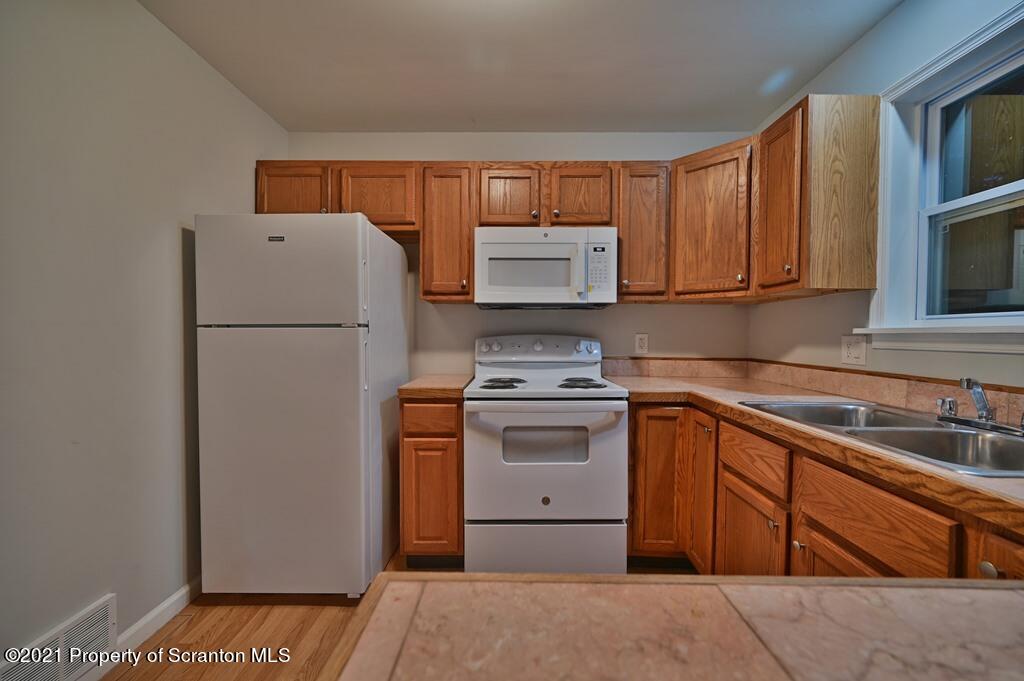 978 Goose Pond Road Lake Ariel, PA 18436 - Photo 19 of 44 a kitchen with a refrigerator sink and stove