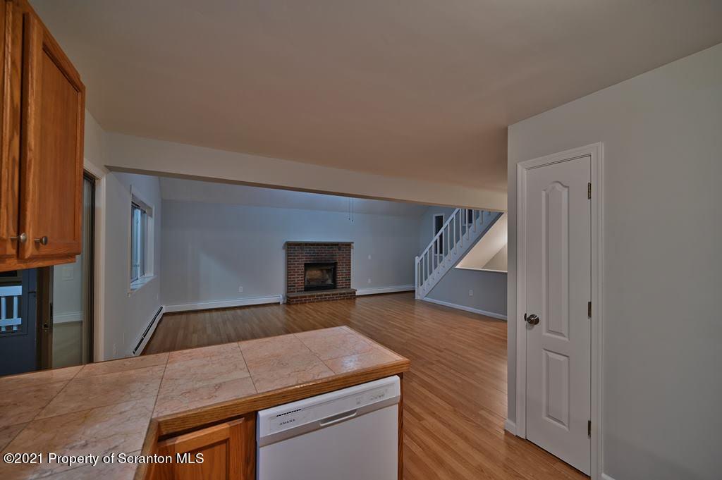 978 Goose Pond Road Lake Ariel, PA 18436 - Photo 20 of 44 a room with kitchen island a stove and wooden floor