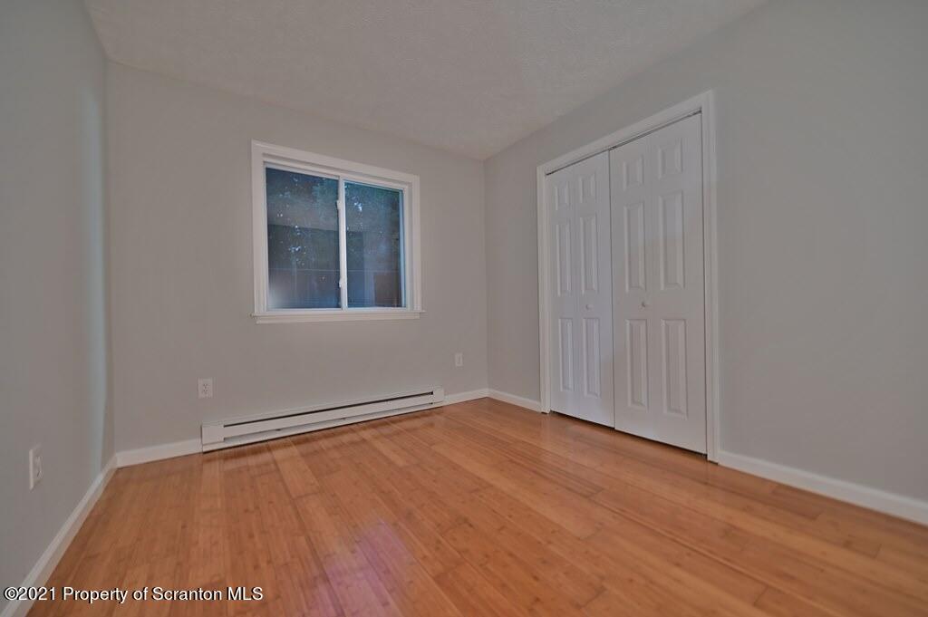 978 Goose Pond Road Lake Ariel, PA 18436 - Photo 28 of 44 a view of an empty room with wooden floor and a window