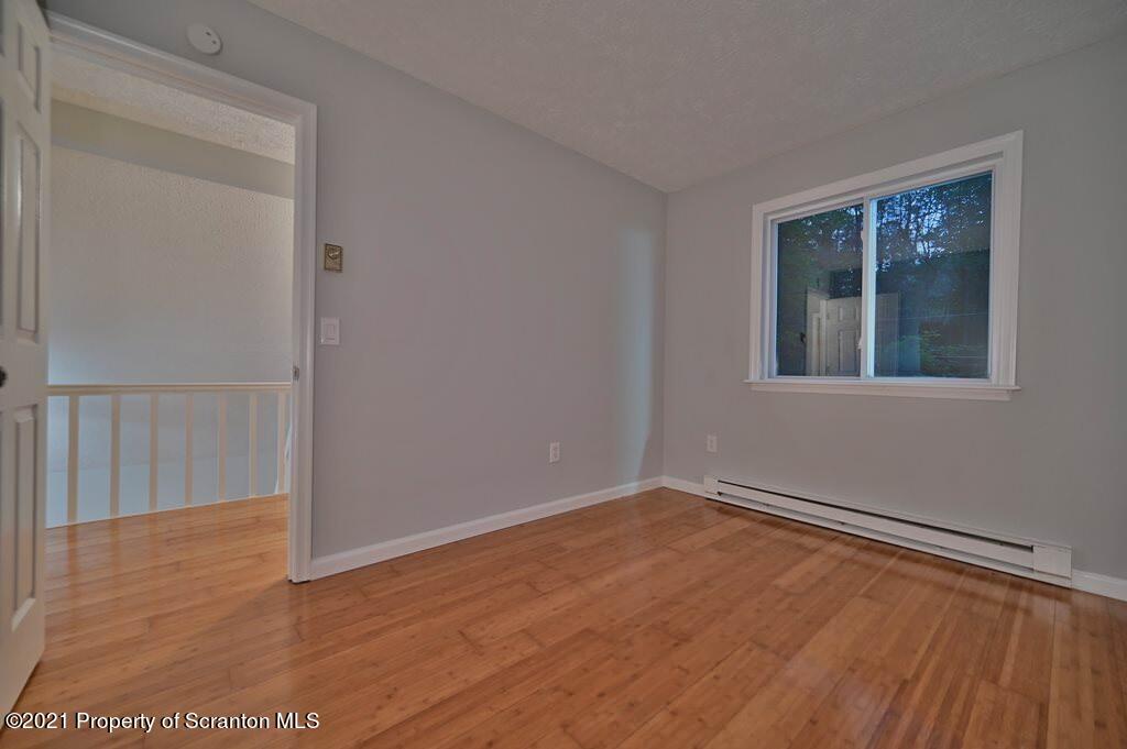 978 Goose Pond Road Lake Ariel, PA 18436 - Photo 29 of 44 a view of an empty room with wooden floor and a window