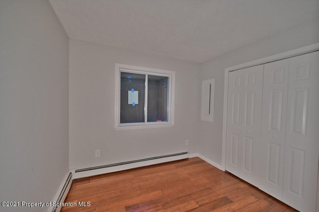 978 Goose Pond Road Lake Ariel, PA 18436 - Photo 41 of 44 a view of an empty room with wooden floor and a window
