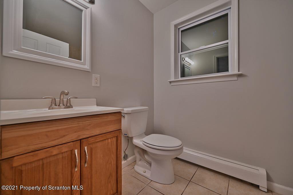 978 Goose Pond Road Lake Ariel, PA 18436 - Photo 42 of 44 a bathroom with a sink a toilet and mirror