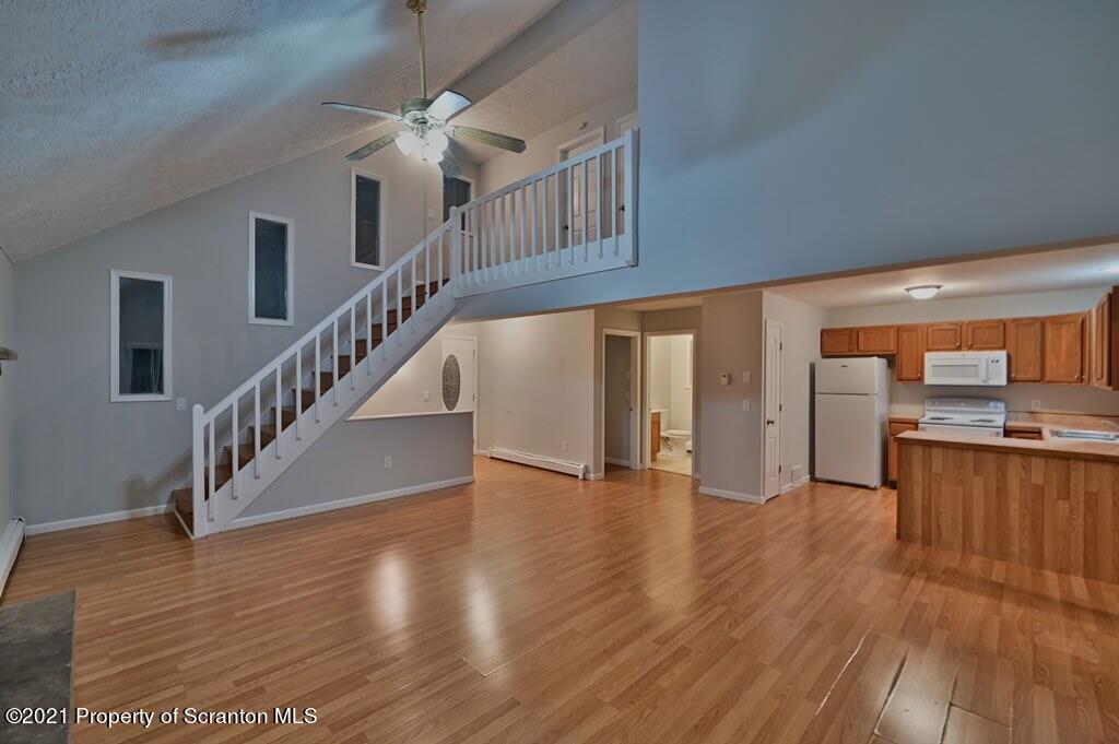 978 Goose Pond Road Lake Ariel, PA 18436 - Photo 8 of 44 a view of a hallway with wooden floor kitchen view and a window