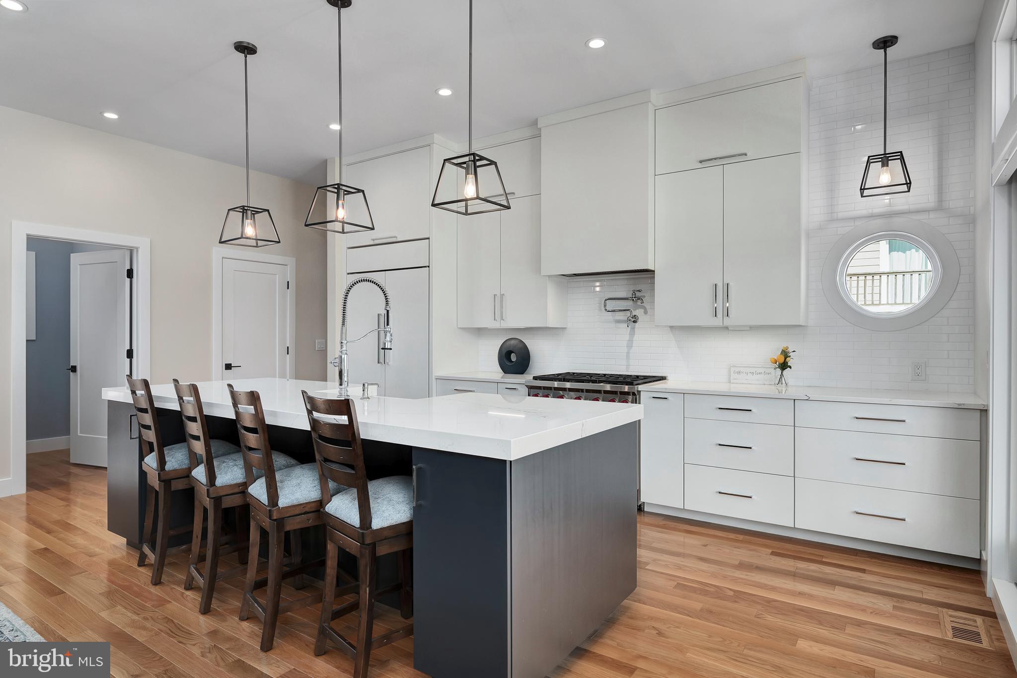 29 Amherst Road Long Beach Township, NJ 08006 - Photo 13 of 56 a kitchen with a stove a sink a dining table and chairs
