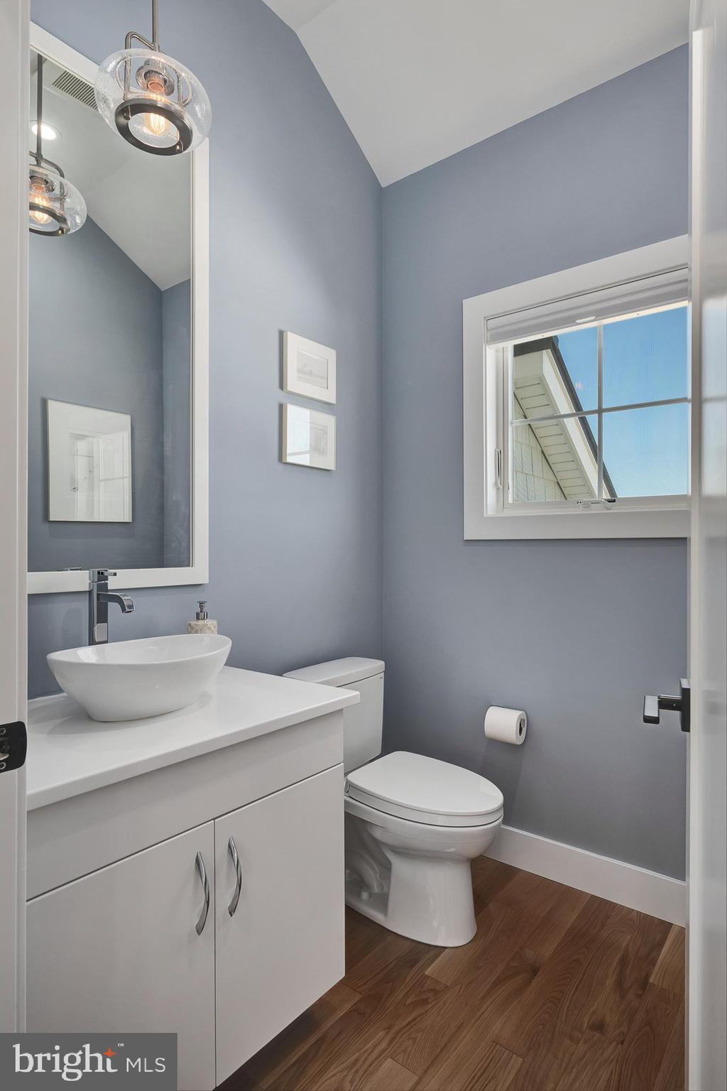 29 Amherst Road Long Beach Township, NJ 08006 - Photo 18 of 56 a bathroom with a toilet a sink and mirror
