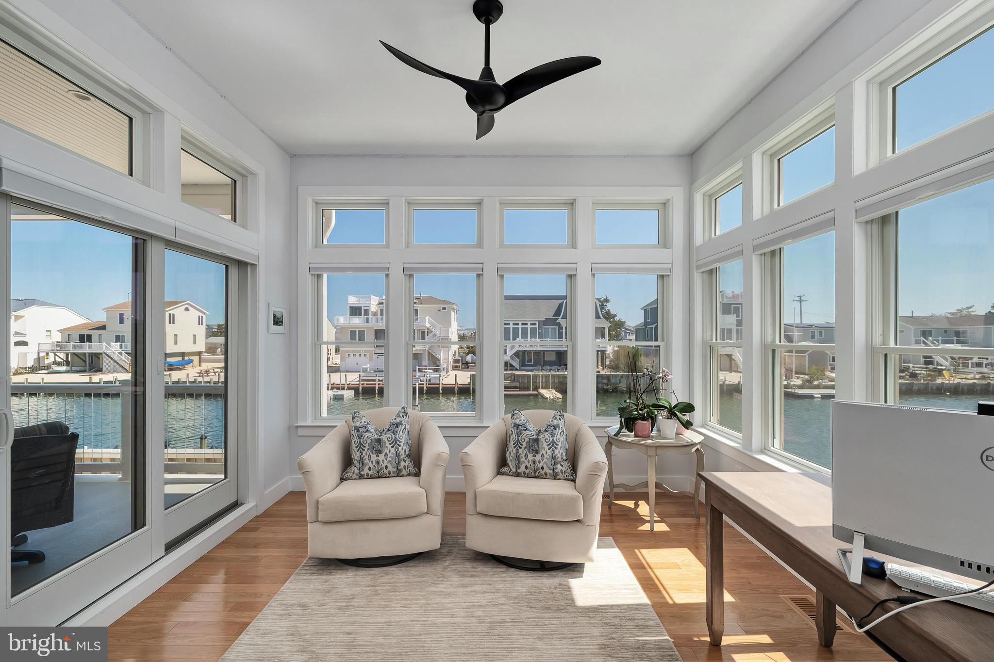 29 Amherst Road Long Beach Township, NJ 08006 - Photo 24 of 56 a living room with furniture a large window and a chandelier