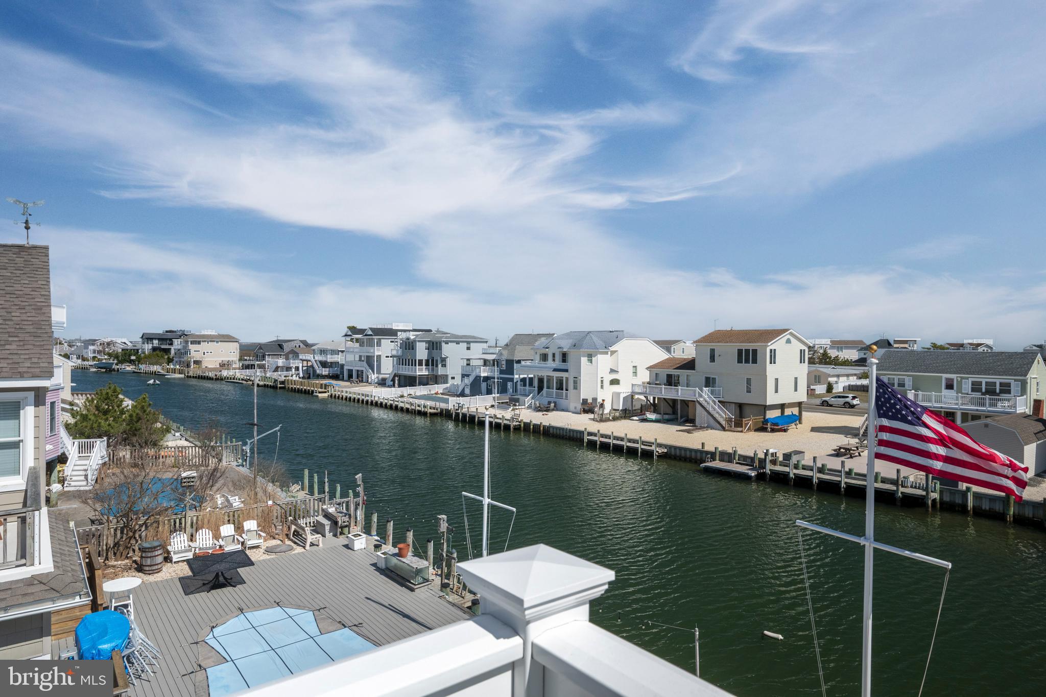 29 Amherst Road Long Beach Township, NJ 08006 - Photo 34 of 56 a view of a lake with a table and chairs