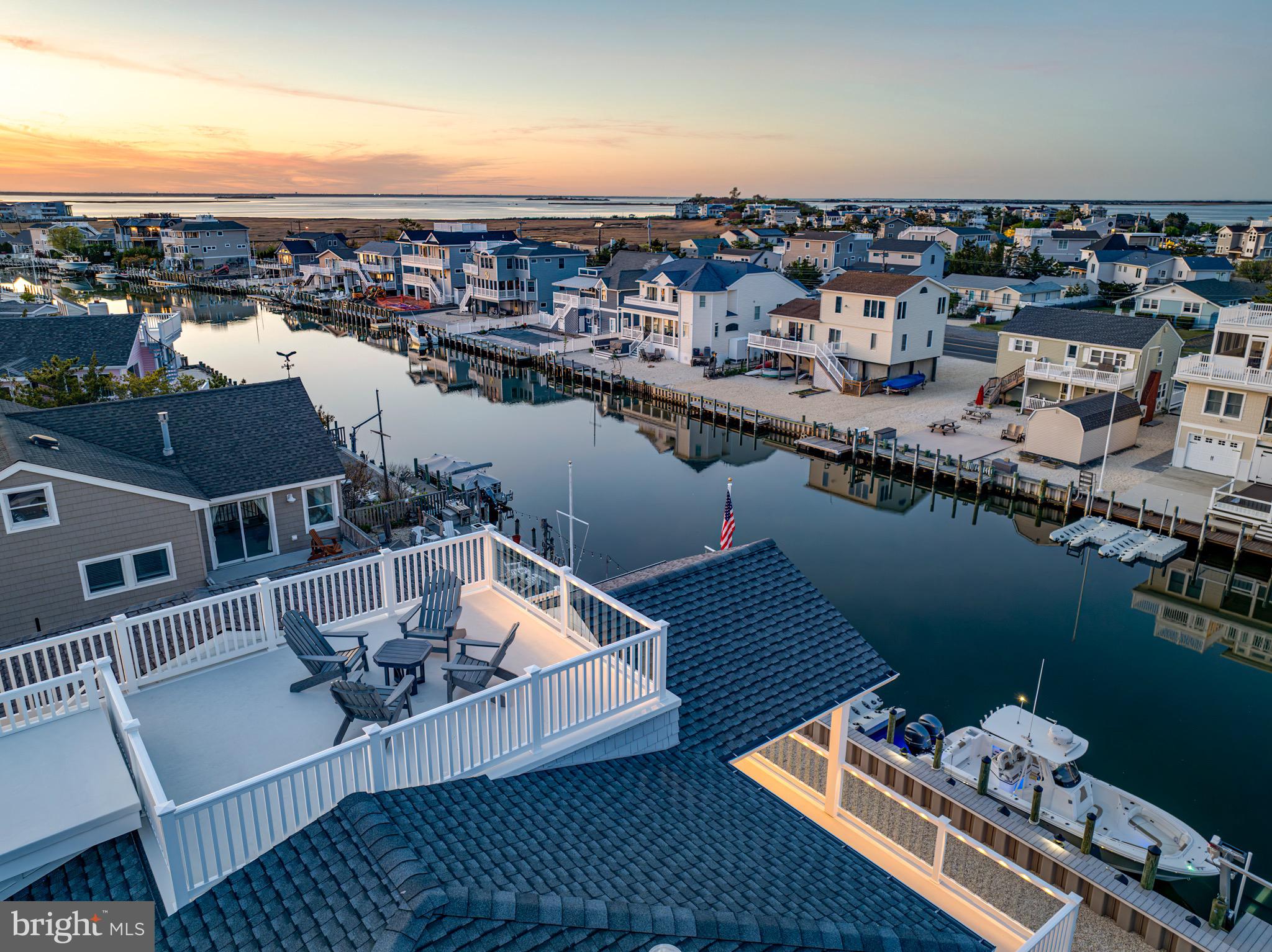 29 Amherst Road Long Beach Township, NJ 08006 - Photo 35 of 56 an aerial view of a house with roof deck outdoor dining table and chairs