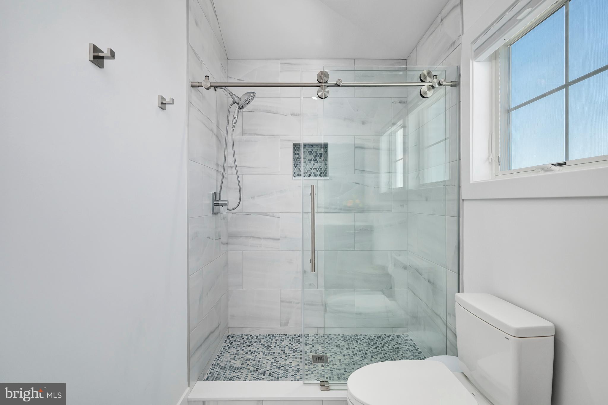 29 Amherst Road Long Beach Township, NJ 08006 - Photo 42 of 56 a bathroom with a shower a toilet and a sink