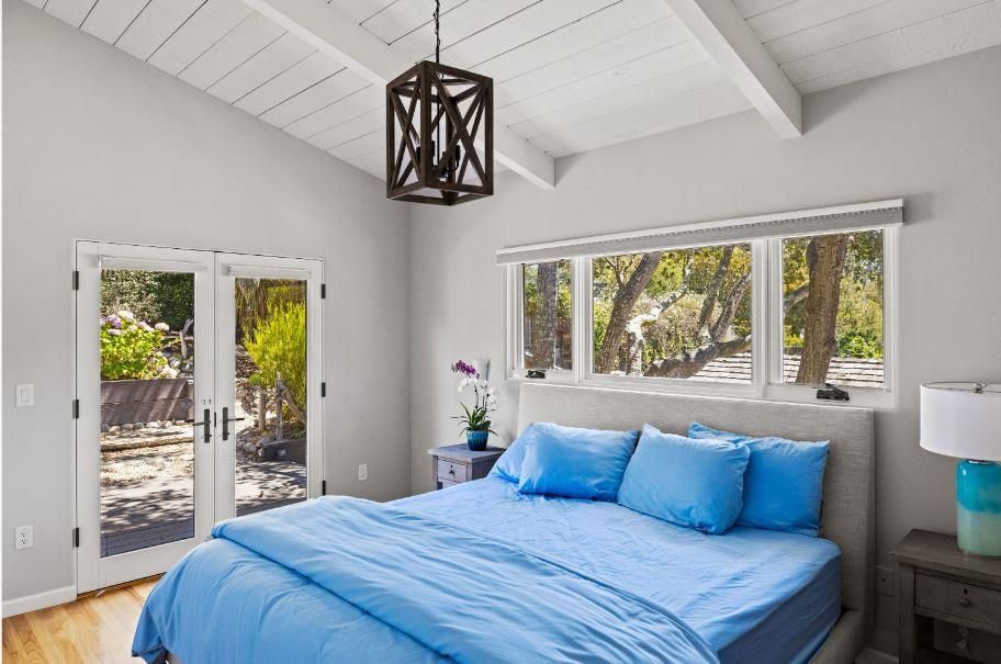 Junipero Street Carmel, CA 93921 - Photo 12 of 33 a bedroom with a large bed and a large window
