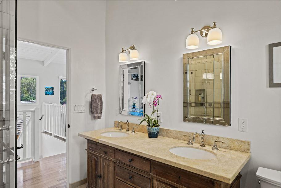 Junipero Street Carmel, CA 93921 - Photo 16 of 33 a bathroom with a sink vanity granite and a mirror