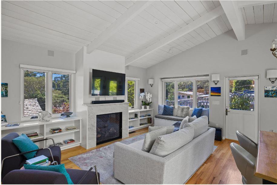 Junipero Street Carmel, CA 93921 - Photo 4 of 33 a living room with furniture a flat screen tv and a fireplace