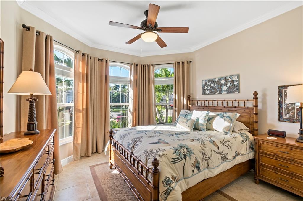 19912 Maddelena Circle Estero, FL 33967 - Photo 11 of 20 a bedroom with a large bed and a chandelier