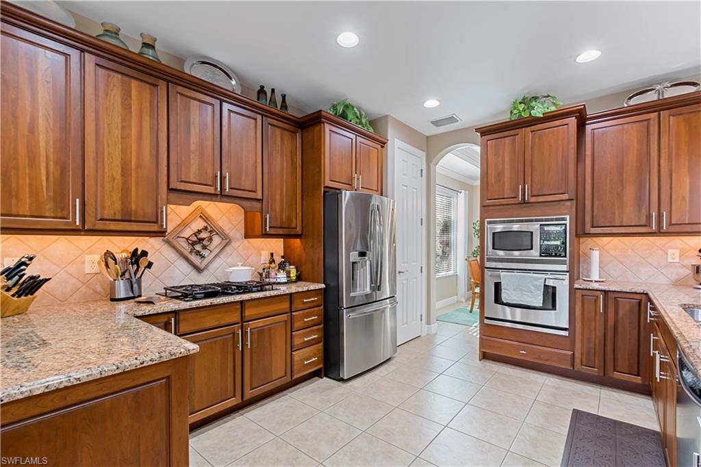 19912 Maddelena Circle Estero, FL 33967 - Photo 3 of 20 a kitchen with stainless steel appliances granite countertop a refrigerator and a sink