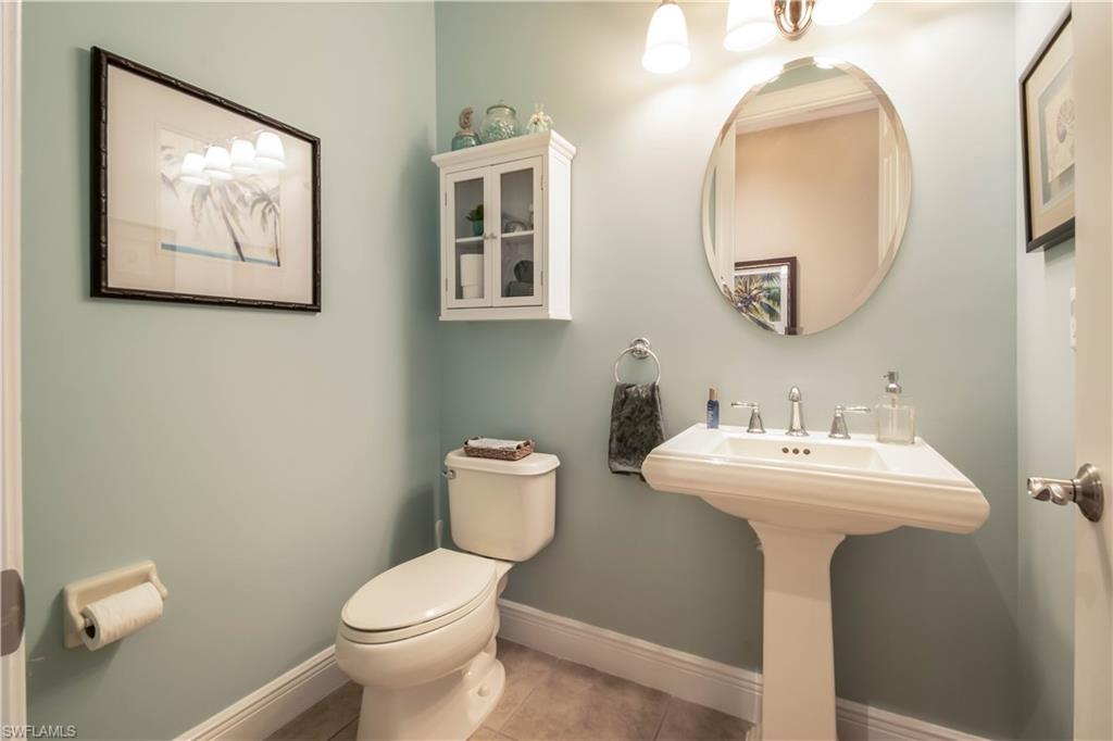 19912 Maddelena Circle Estero, FL 33967 - Photo 10 of 20 a bathroom with a toilet sink and mirror