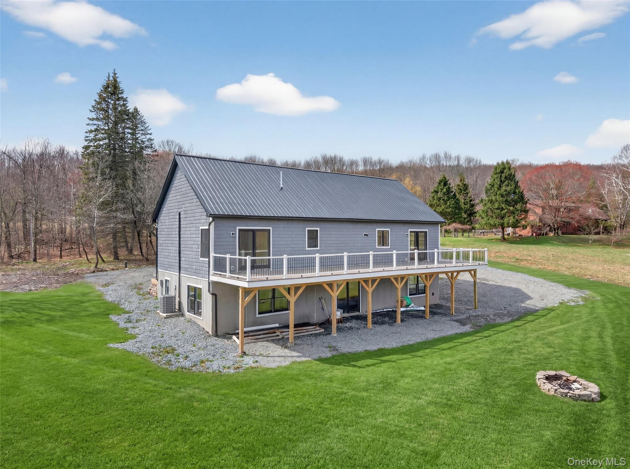 a view of a house with a yard patio and sitting area