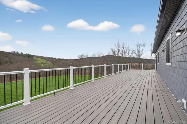 a view of a house with wooden deck