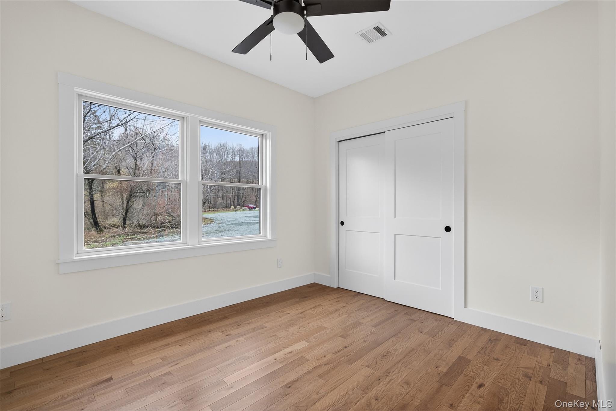 129 Nelson Road Hankins, NY 12741 - Photo 18 of 31 a view of an empty room with wooden floor and a window
