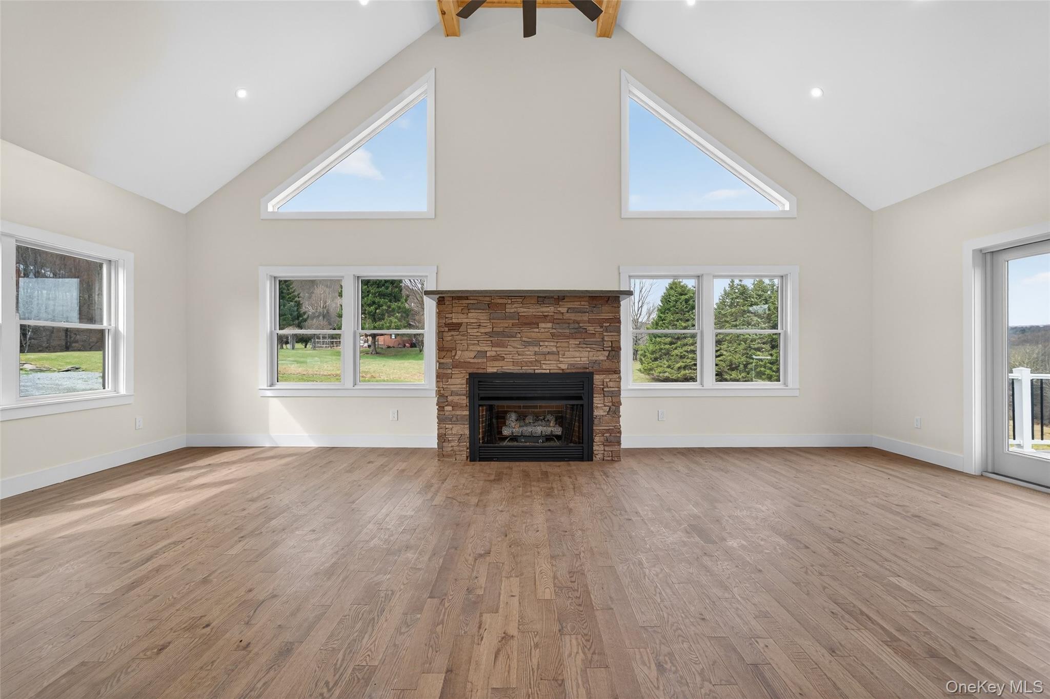 129 Nelson Road Hankins, NY 12741 - Photo 2 of 31 an empty room with windows and fireplace