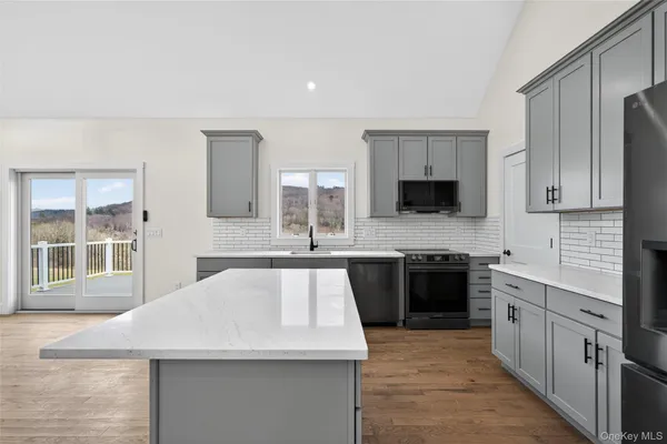 a kitchen with a sink stove and microwave