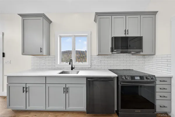 a kitchen with stainless steel appliances a stove sink and cabinets