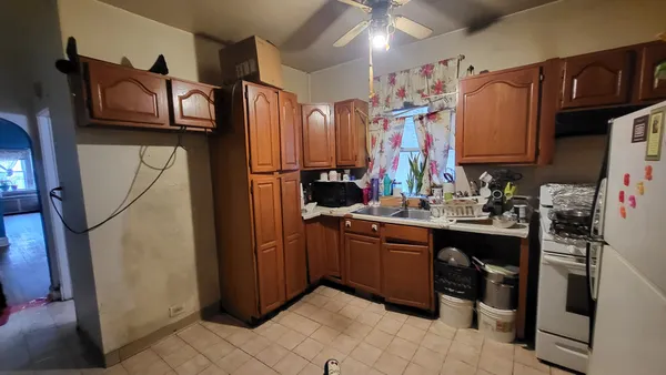 a storage room with water heater and refrigerator