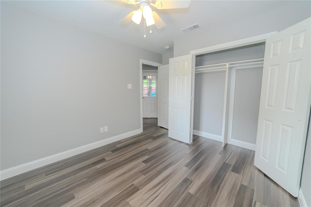 809 Wilcox Street McKinney, TX 75069 - Photo 20 of 26 Unfurnished bedroom featuring a ceiling fan, dark wood-style flooring, and a closet