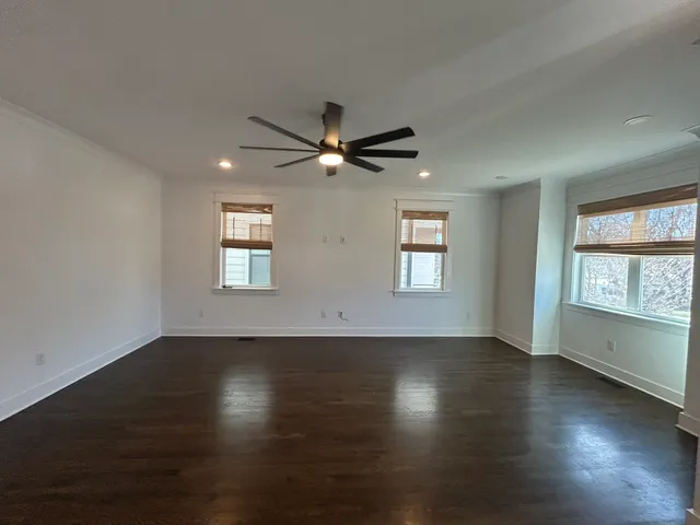 a view of wooden floor and windows in an empty room
