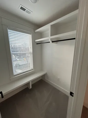 a spacious bathroom with a double vanity sink a mirror and a shower