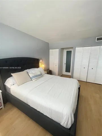 a bedroom with a bed and cabinets