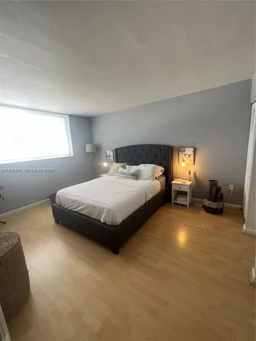 a spacious bedroom with a bed and a couch