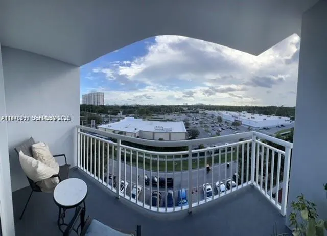 a view of a balcony with chair and wooden floor